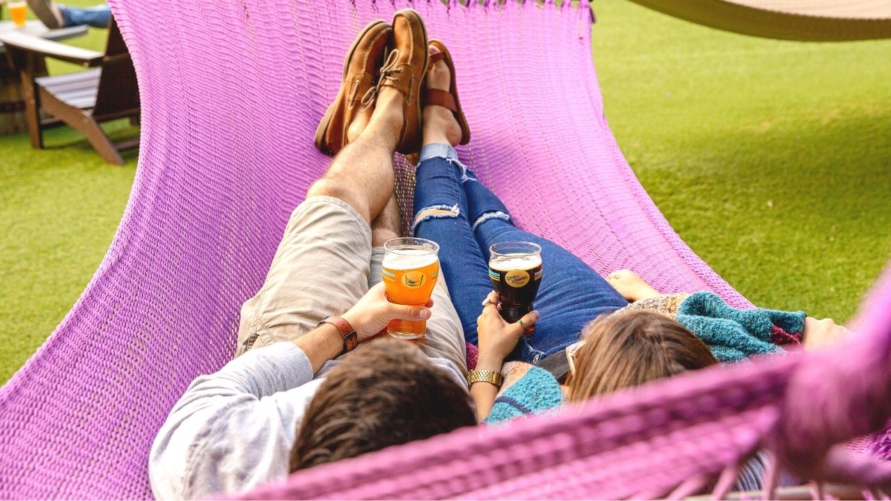 Couple Laying on Hammock with Beers