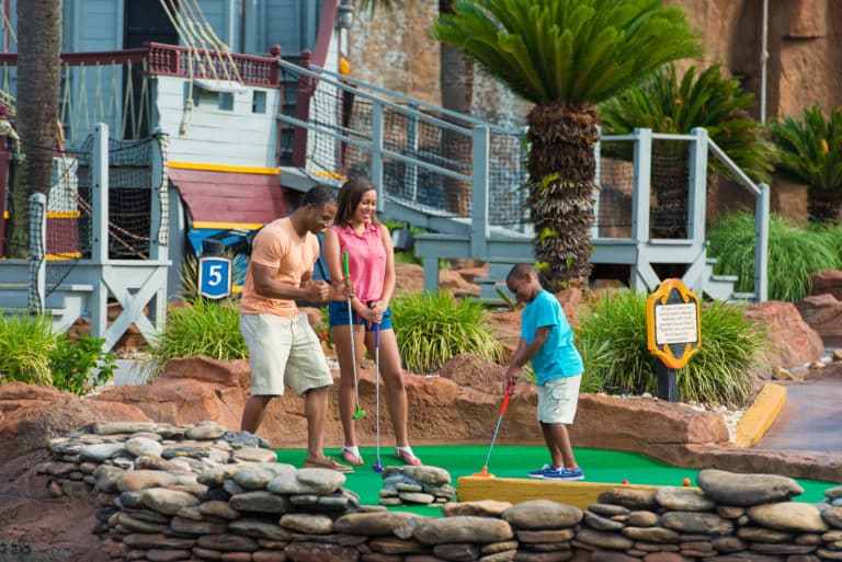 family playing mini golf