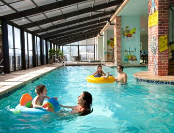 Caribbean Family Swimming in Indoor Pool