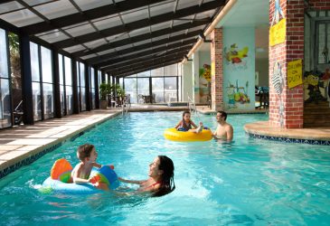 Caribbean Family Swimming in Indoor Pool