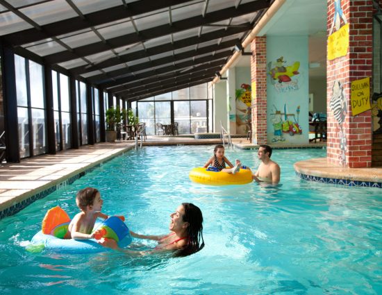 Caribbean Family Swimming in Indoor Pool