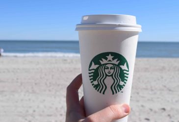 starbucks hot cup on the beach
