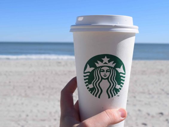 starbucks hot cup on the beach