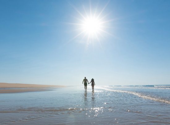 beach-couple-walking-takeover-bg-image.jpg