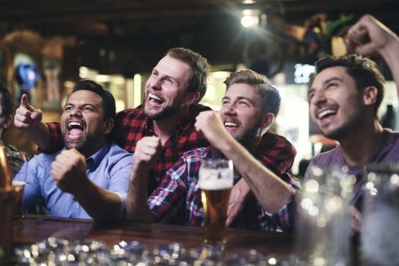 Excited Guys Watching Football at a Bar